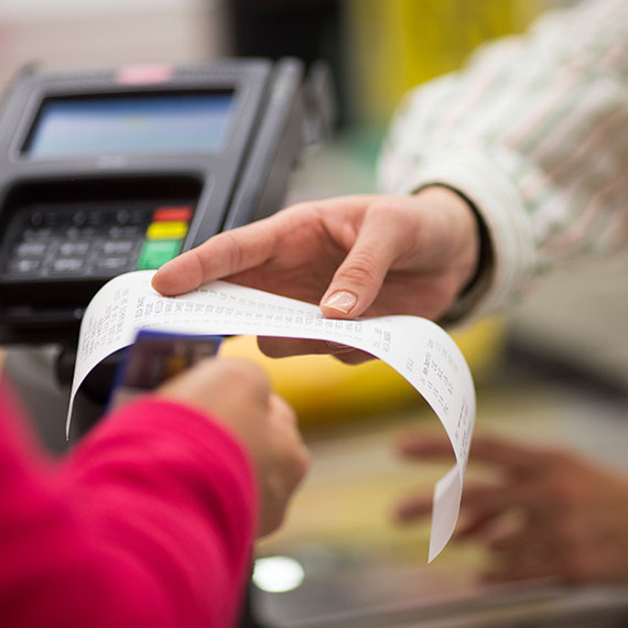 cashier hands the client the receipt