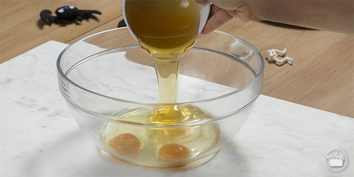 Echar en un bol los huevos y la miel. 